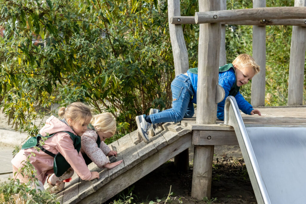 Children climbing in the playhouse outside the childcare centre